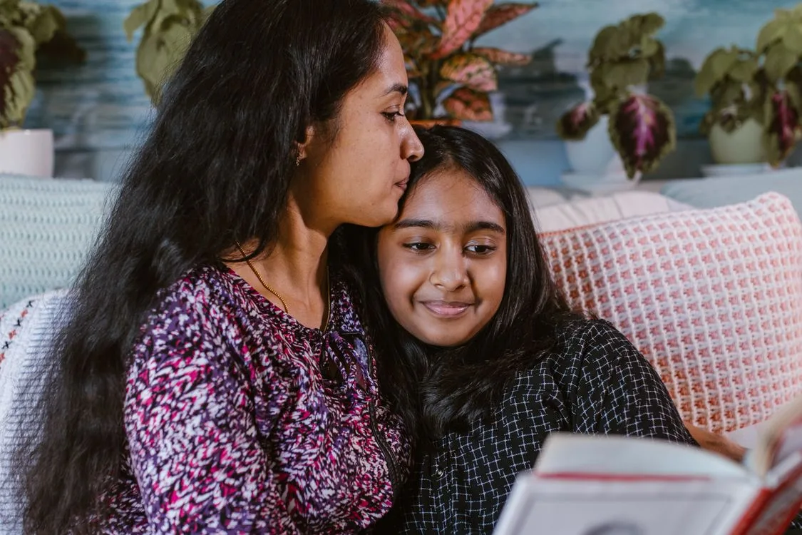 Mother and daughter smiling together