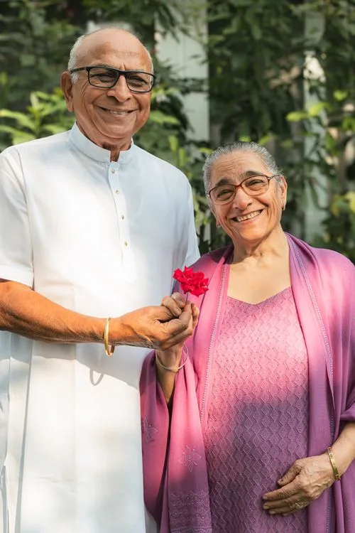 Elderly Indian couple smiling together outdoors