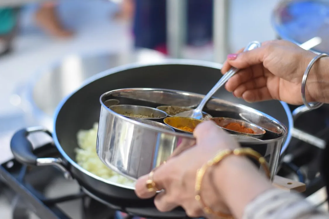 Hands preparing a meal in a home kitchen