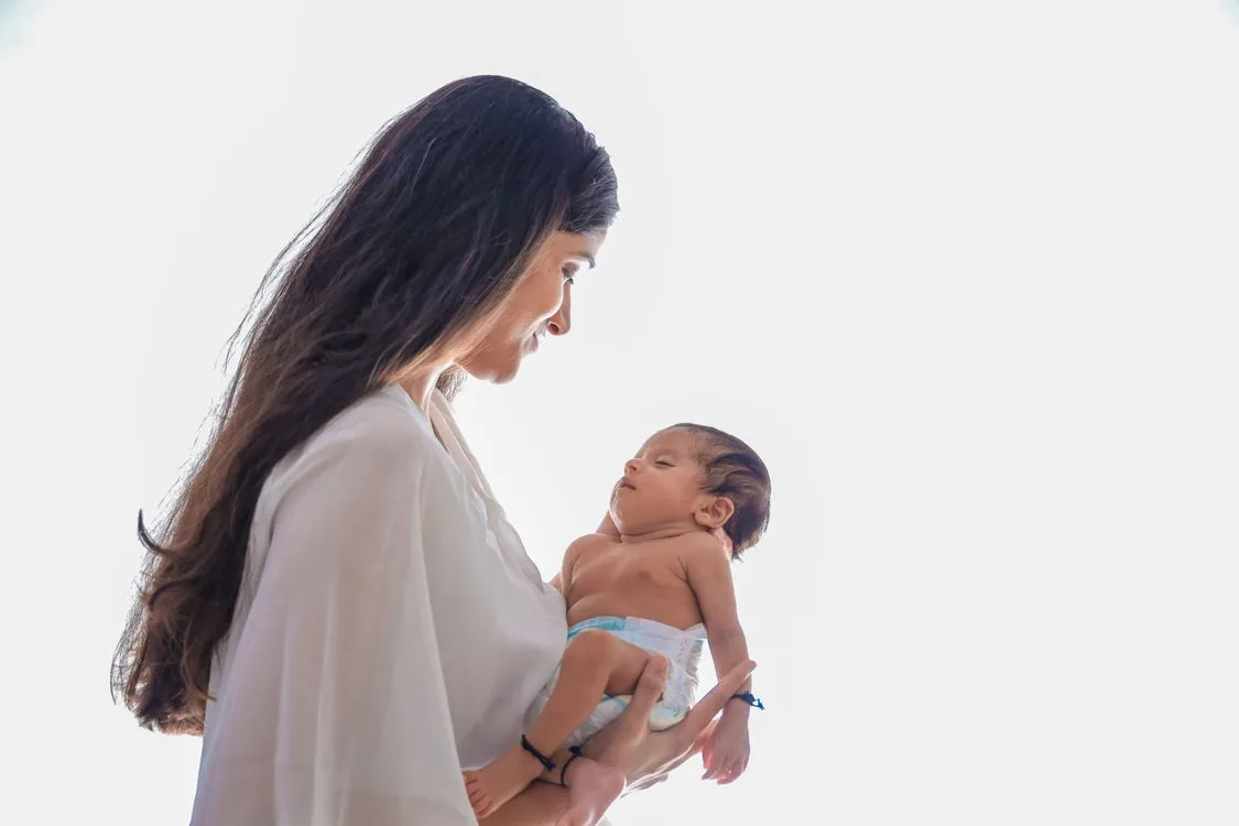Mother holding her newborn baby in soft natural light